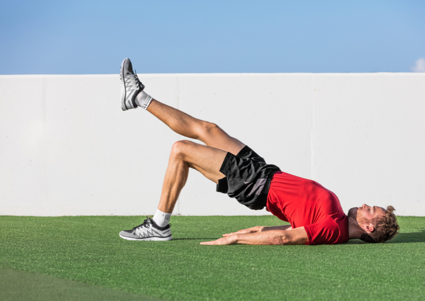 man performing single-leg glute bridges upper glute exercise